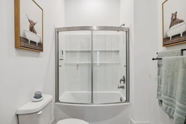 a bathroom with a toilet and a shower