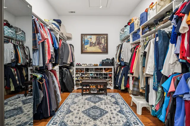 a view of walk in closet with clothes
