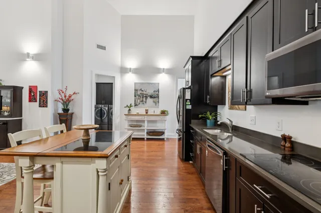 a kitchen with stainless steel appliances a sink stove and refrigerator