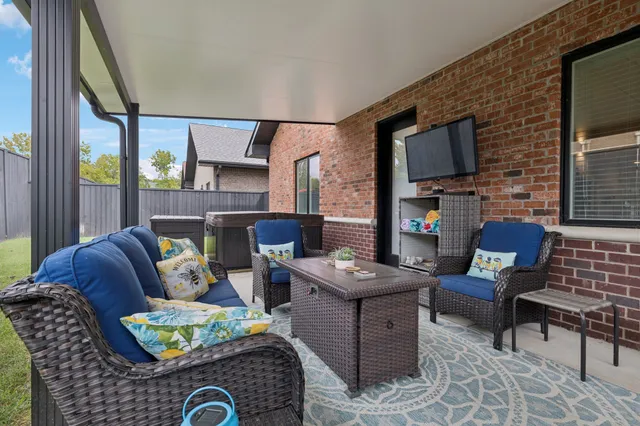 a living room with furniture fireplace and a flat screen tv