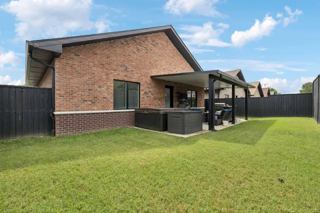 a view of a house with a yard and a garden