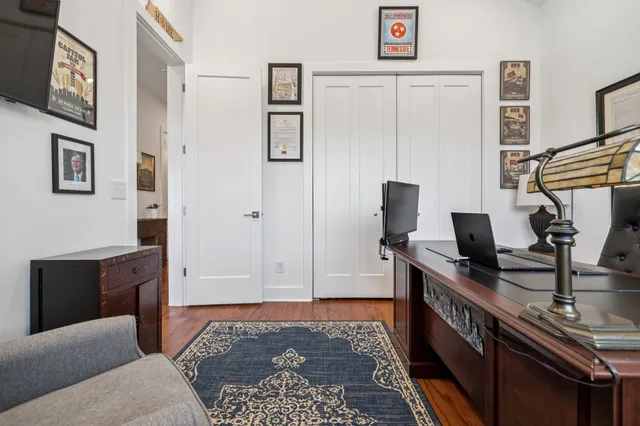 a bedroom with furniture and a air conditioner vent