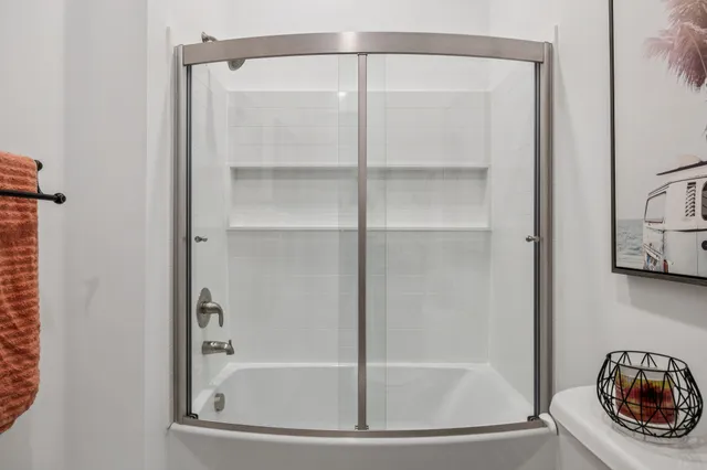 a bathroom with a glass shower door