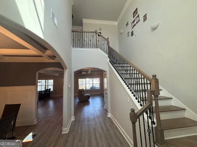 a view of entryway and hall with wooden floor