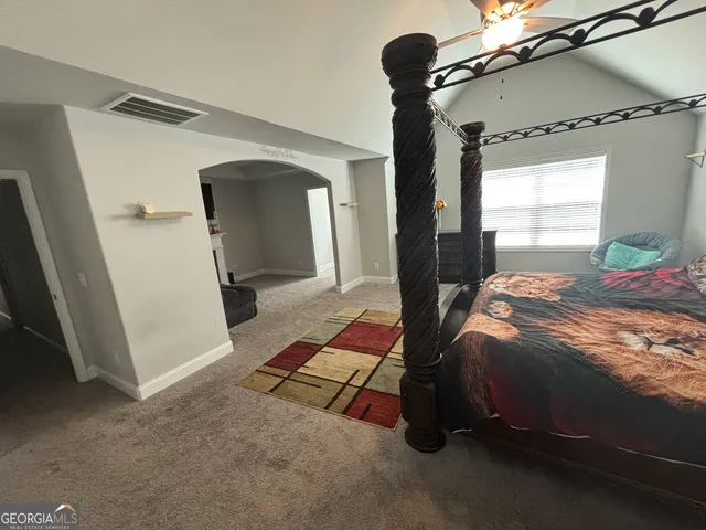 a bed room with a bed and a mirror