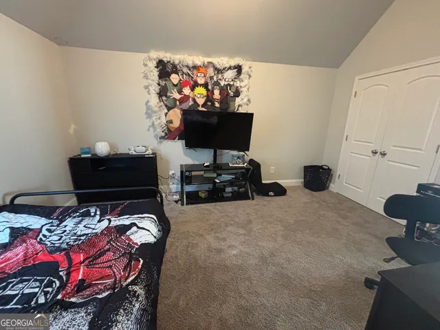 a bed room with bed and a chair