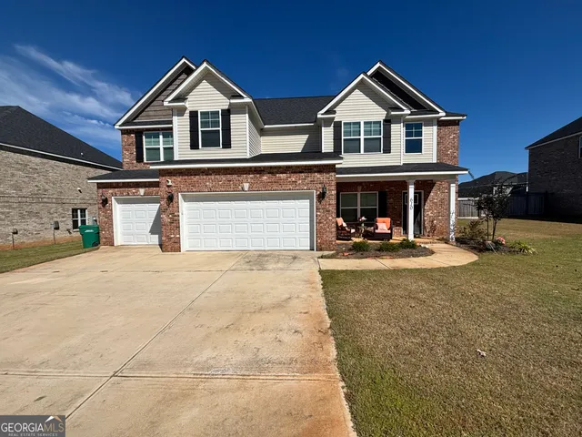 a front view of a house with a yard and garage