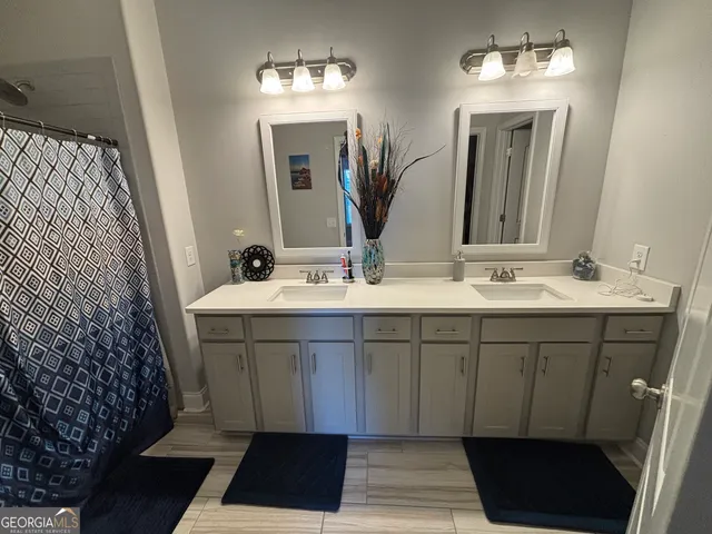a bathroom with a sink a mirror and a shower