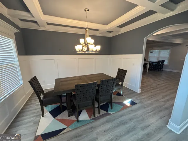 a view of a dining room with furniture and chandelier