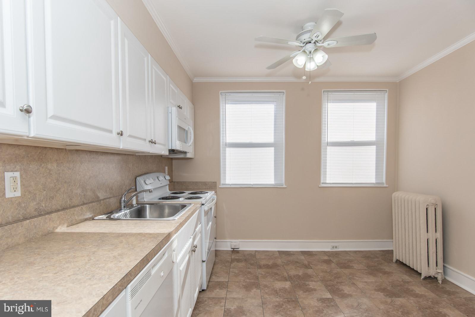 7119 Gillespie Street Philadelphia, PA 19135 - Photo 14 of 47 a kitchen with a sink a window and cabinets