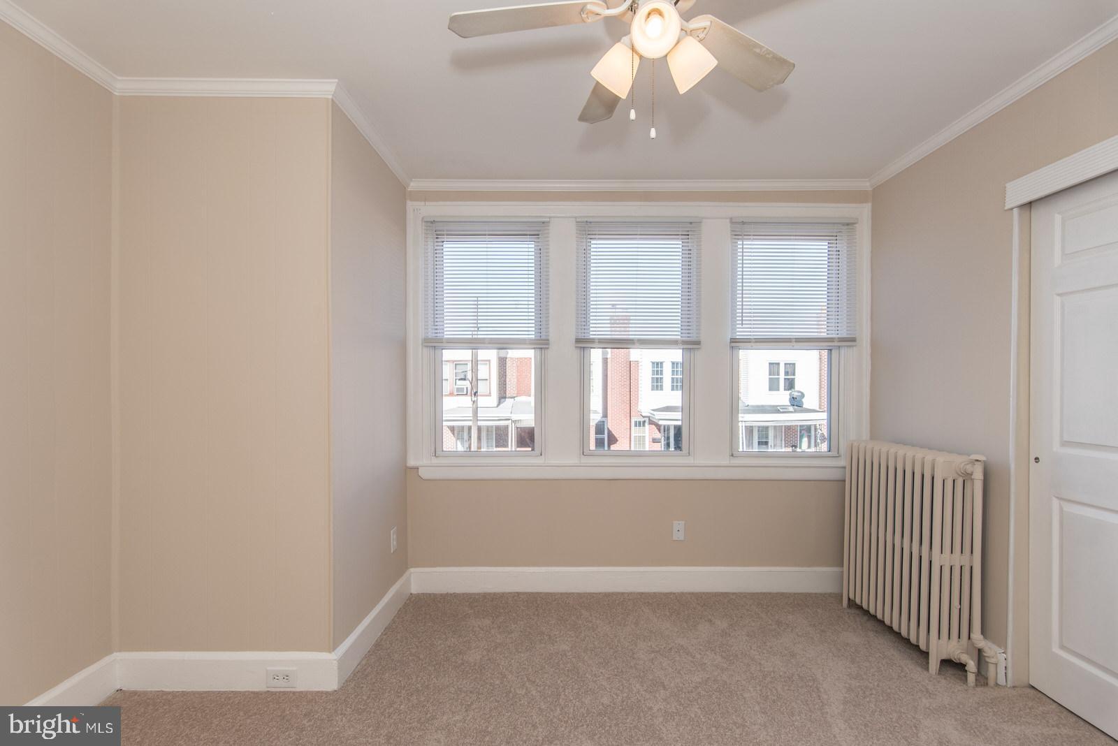7119 Gillespie Street Philadelphia, PA 19135 - Photo 21 of 47 an empty room with windows and chandelier fan