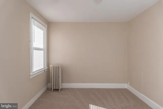 a view of a livingroom with a chandelier fan and closet