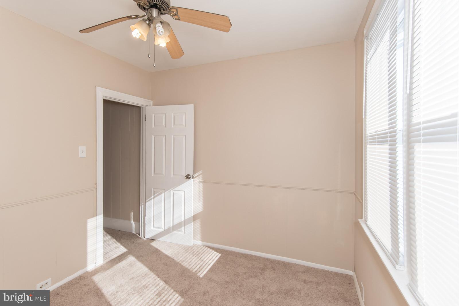 7119 Gillespie Street Philadelphia, PA 19135 - Photo 31 of 47 an empty room with chandelier fan and windows