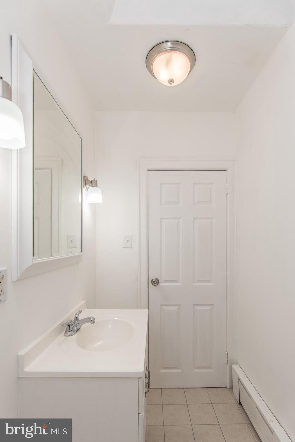 7119 Gillespie Street Philadelphia, PA 19135 - Photo 34 of 47 a bathroom with a sink a toilet and a mirror