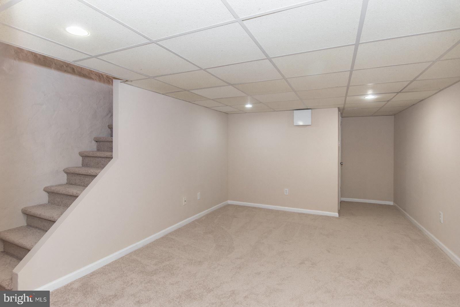 7119 Gillespie Street Philadelphia, PA 19135 - Photo 39 of 47 an empty room with wooden floor and windows