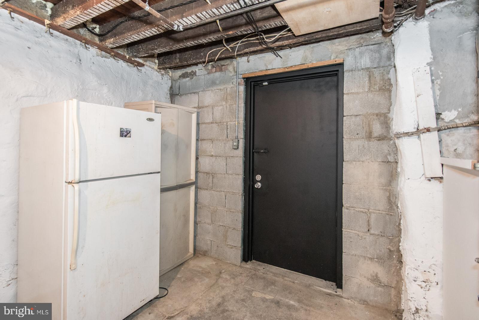 7119 Gillespie Street Philadelphia, PA 19135 - Photo 43 of 47 a white refrigerator freezer and a stove sitting inside of a kitchen