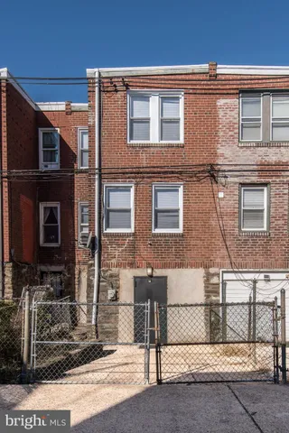 a view of a brick building next to a yard