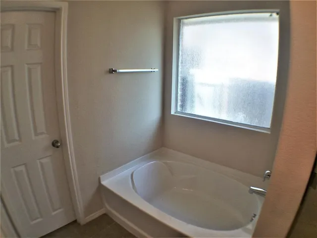 a white bath tub sitting next to a window