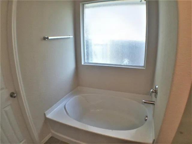 a kitchen with a refrigerator a stove a sink and a window