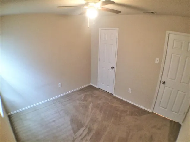 a view of empty room with a fireplace