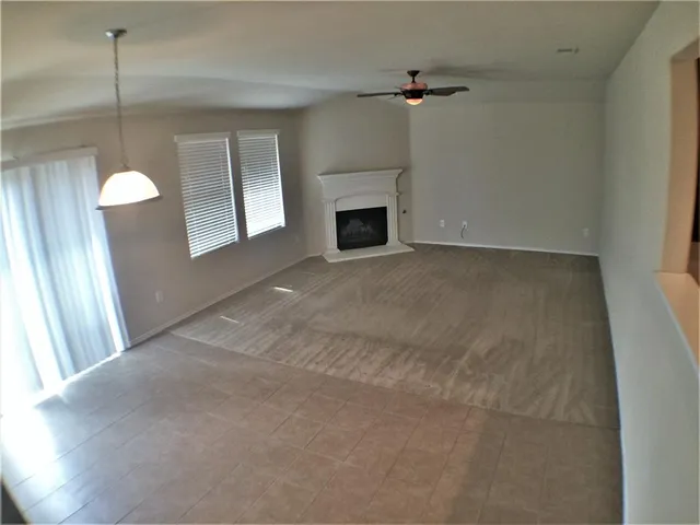 a view of empty room with window and fireplace