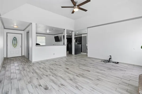 a view of a livingroom with wooden floor and white walls