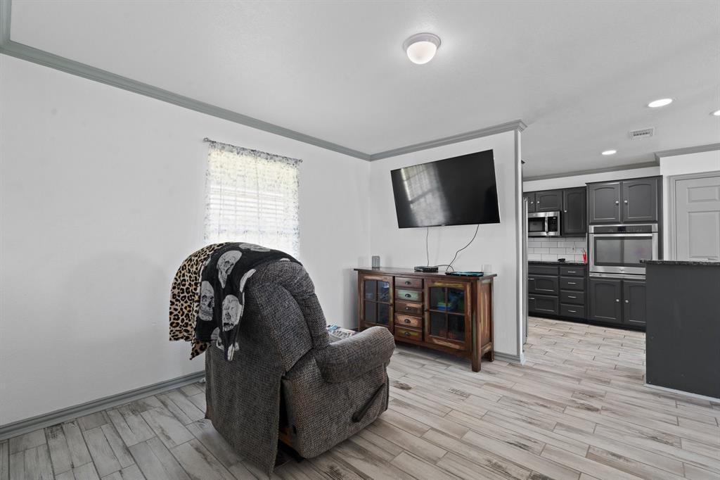2600 Dave Angel Road Burleson, TX 76028 - Photo 14 of 31 a living room with furniture and a flat screen tv