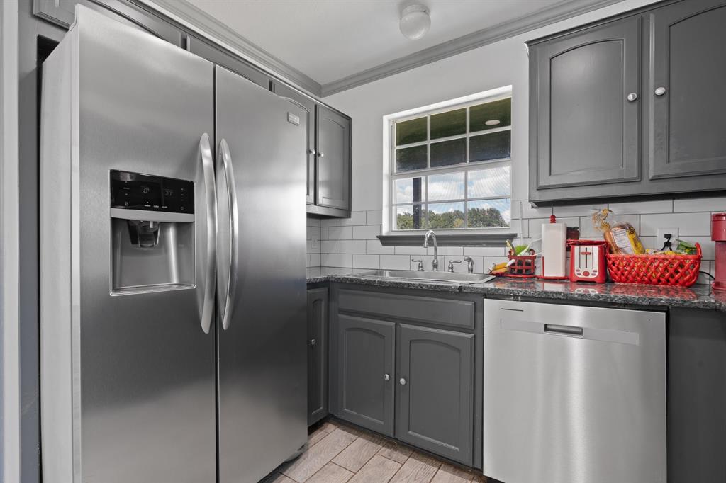 2600 Dave Angel Road Burleson, TX 76028 - Photo 17 of 31 a kitchen with stainless steel appliances granite countertop a refrigerator and a sink
