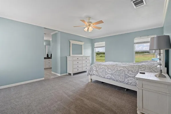 a bedroom with a bed and a lamp