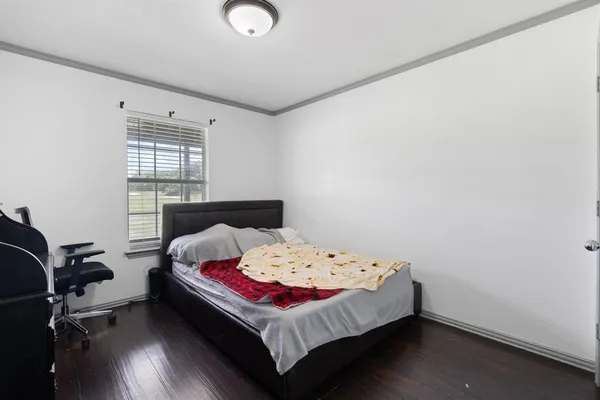 a bed sitting in a bedroom next to a window
