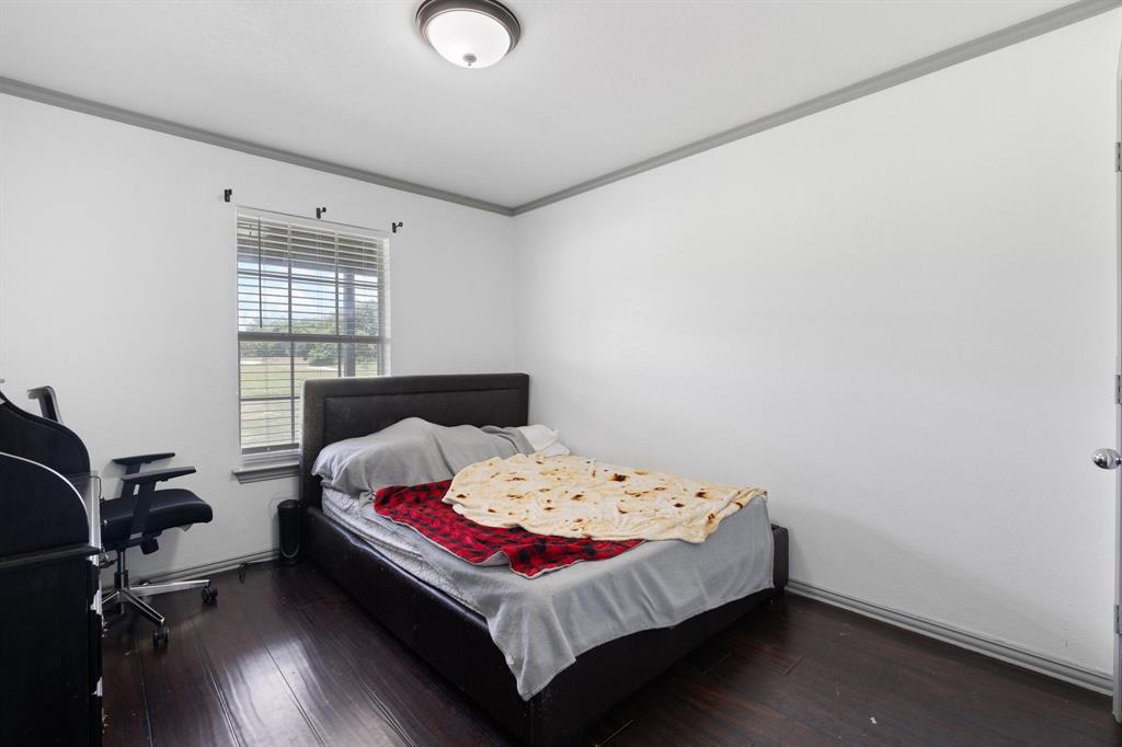 2600 Dave Angel Road Burleson, TX 76028 - Photo 28 of 33 a bedroom with a bed and wooden floor