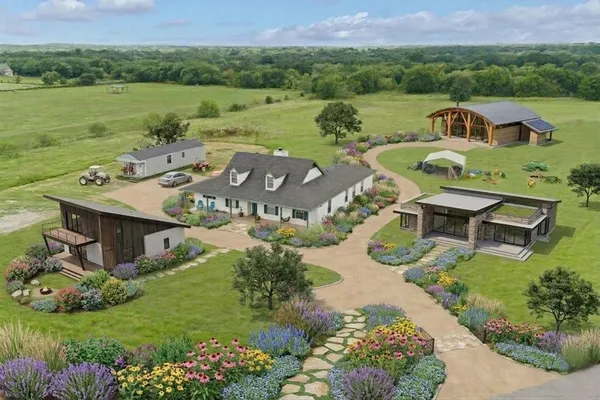 an aerial view of a house with big yard