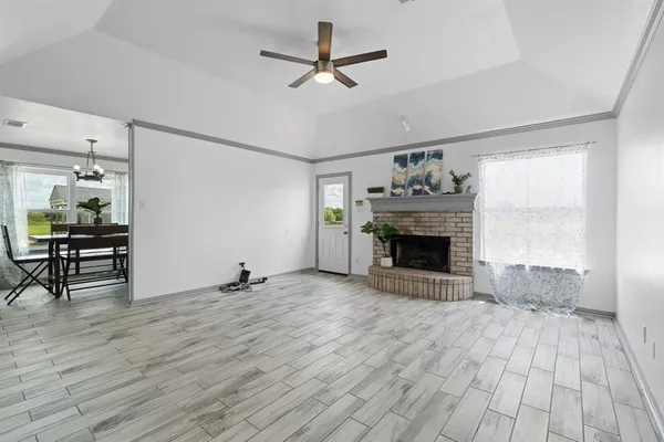 a view of a livingroom with a fireplace and window