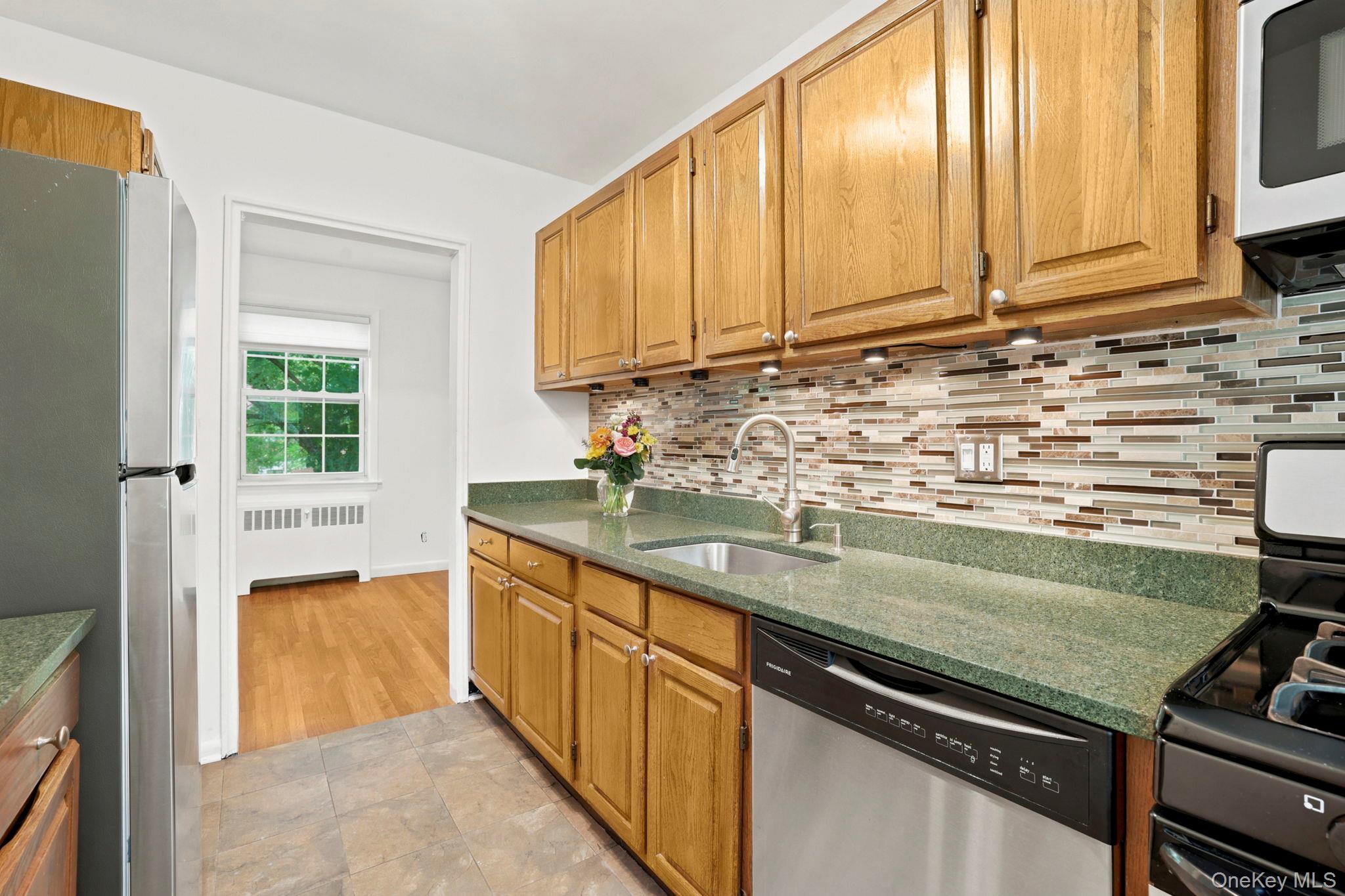 186 Pinewood Road, Unit 56 Hartsdale, NY 10530 - Photo 11 of 29 There are Frigidaire stainless steel appliances, inclusive of a gas range, and a stylish glass tile backsplash, highlighted by the undercounter lighting