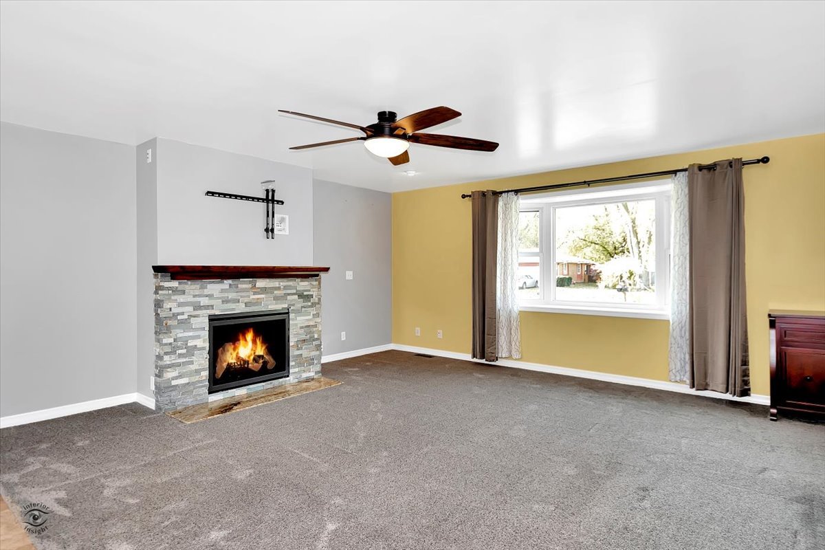302 North Raven Road Shorewood, IL 60404 - Photo 2 of 26 a view of an empty room with window and fireplace