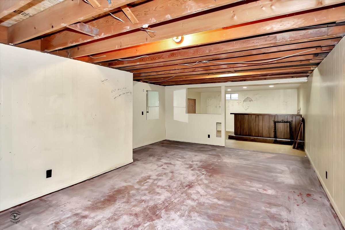 302 North Raven Road Shorewood, IL 60404 - Photo 20 of 26 a view of a room with a fireplace and a chandelier