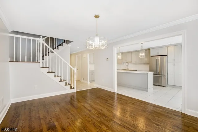 a view of a kitchen with wooden floor and electronic appliances