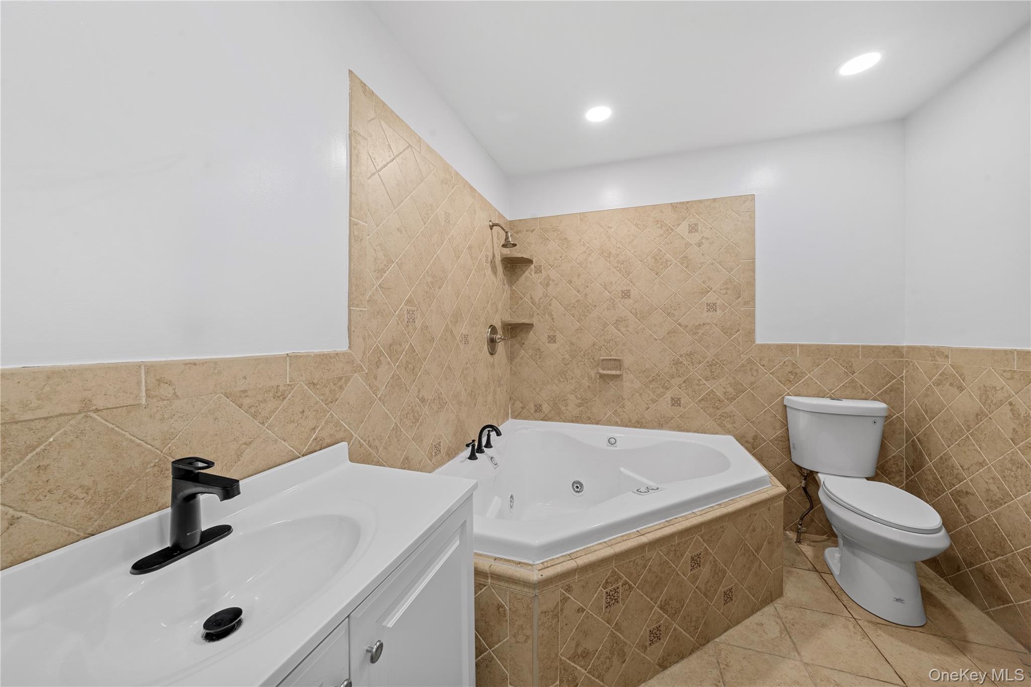 57 Eastwood Road Miller Place, NY 11764 - Photo 15 of 45 a bathroom with a sink and a toilet