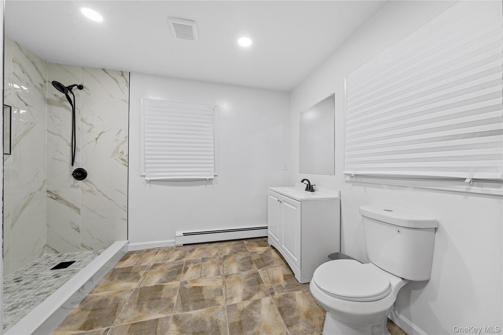 57 Eastwood Road Miller Place, NY 11764 - Photo 17 of 45 a bathroom with a toilet and a shower