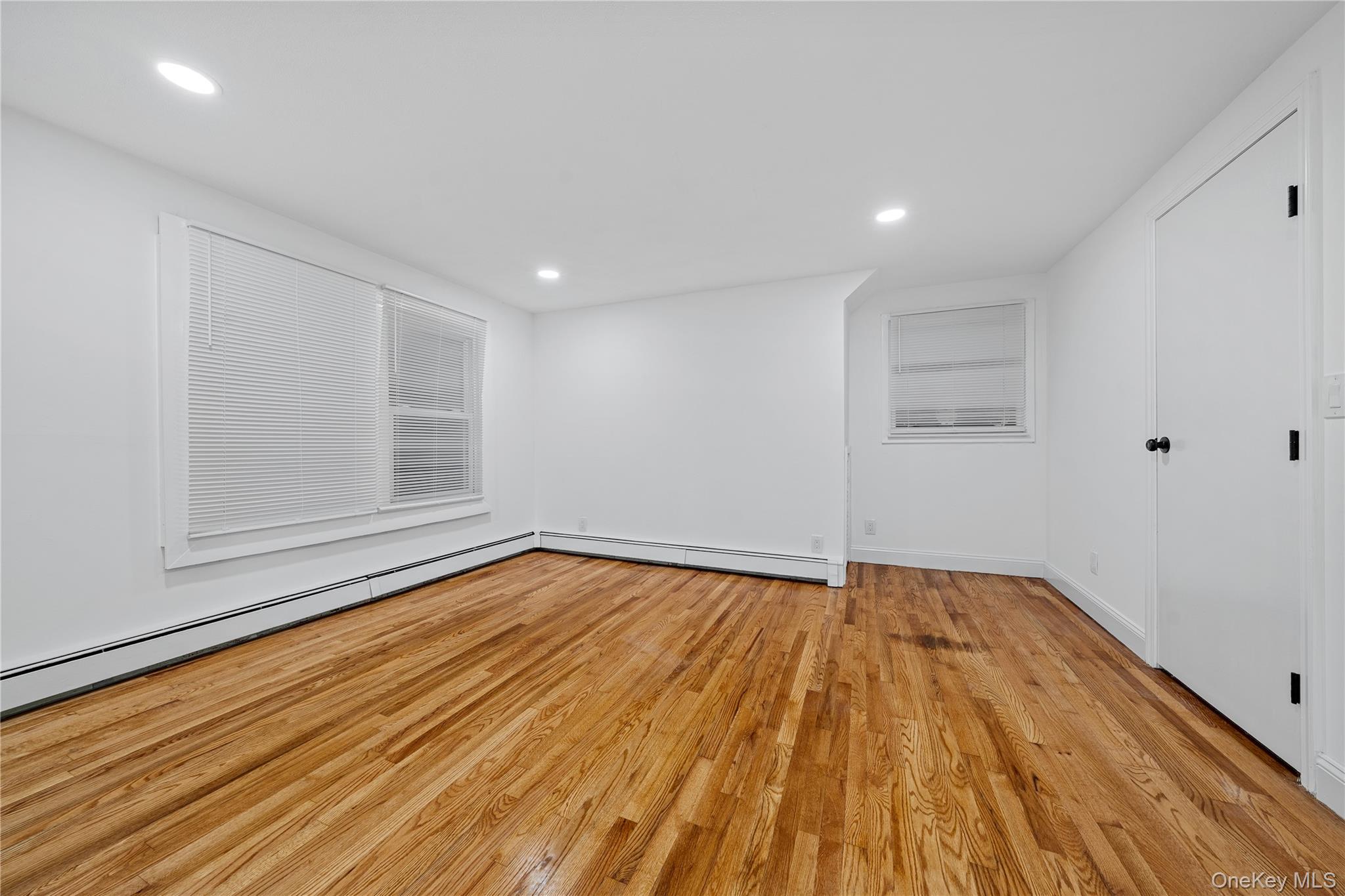 57 Eastwood Road Miller Place, NY 11764 - Photo 22 of 45 a view of empty room with wooden floor and fan