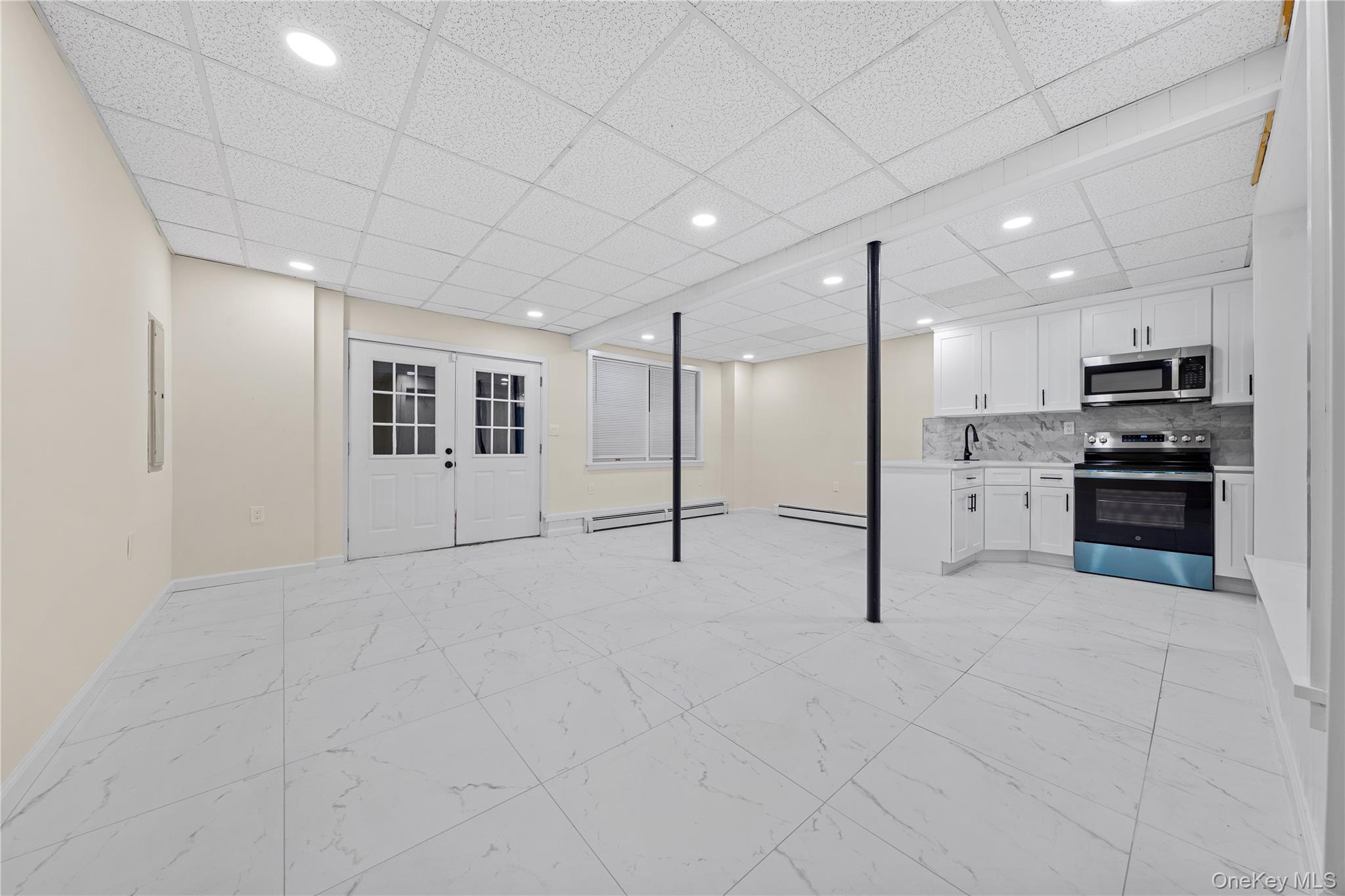 57 Eastwood Road Miller Place, NY 11764 - Photo 27 of 45 a view of an empty room with kitchen and window