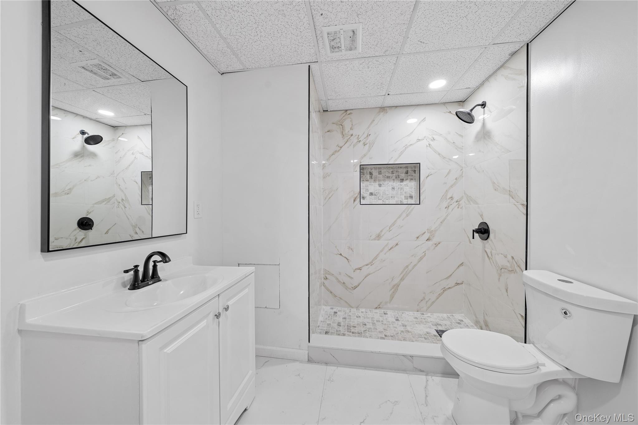 57 Eastwood Road Miller Place, NY 11764 - Photo 30 of 45 a bathroom with a sink toilet and shower