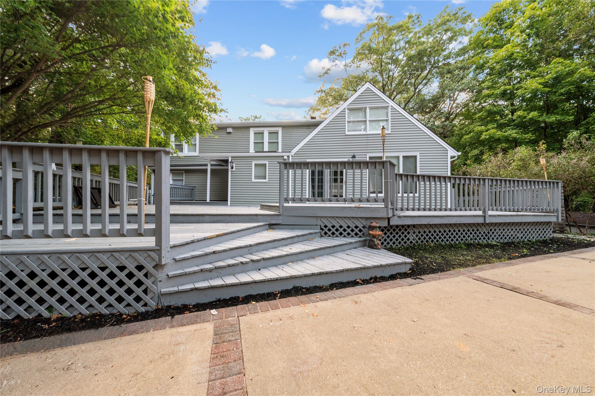 57 Eastwood Road Miller Place, NY 11764 - Photo 34 of 45 a front view of a house with a small yard