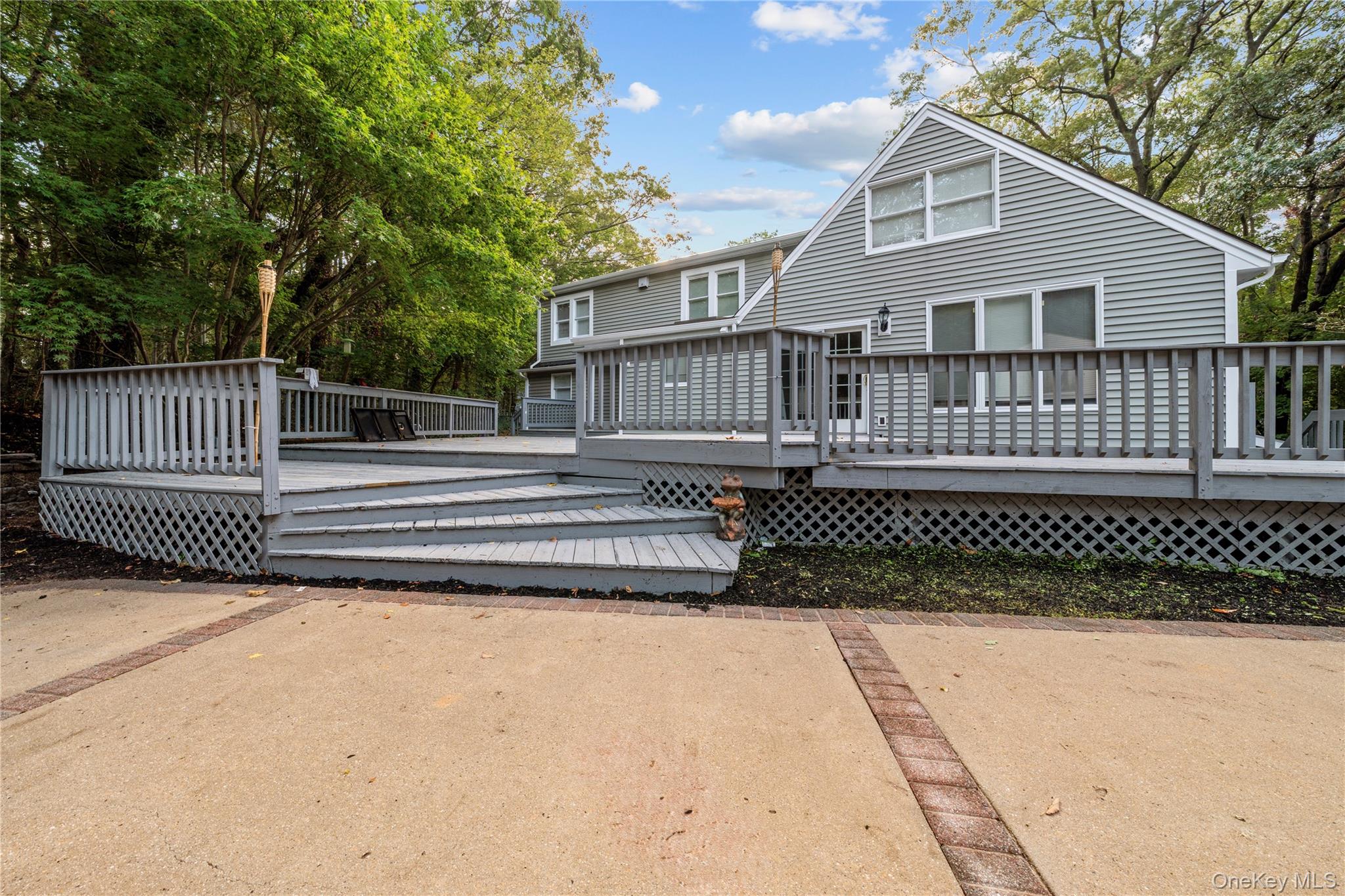 57 Eastwood Road Miller Place, NY 11764 - Photo 35 of 45 a front view of a house with a garden