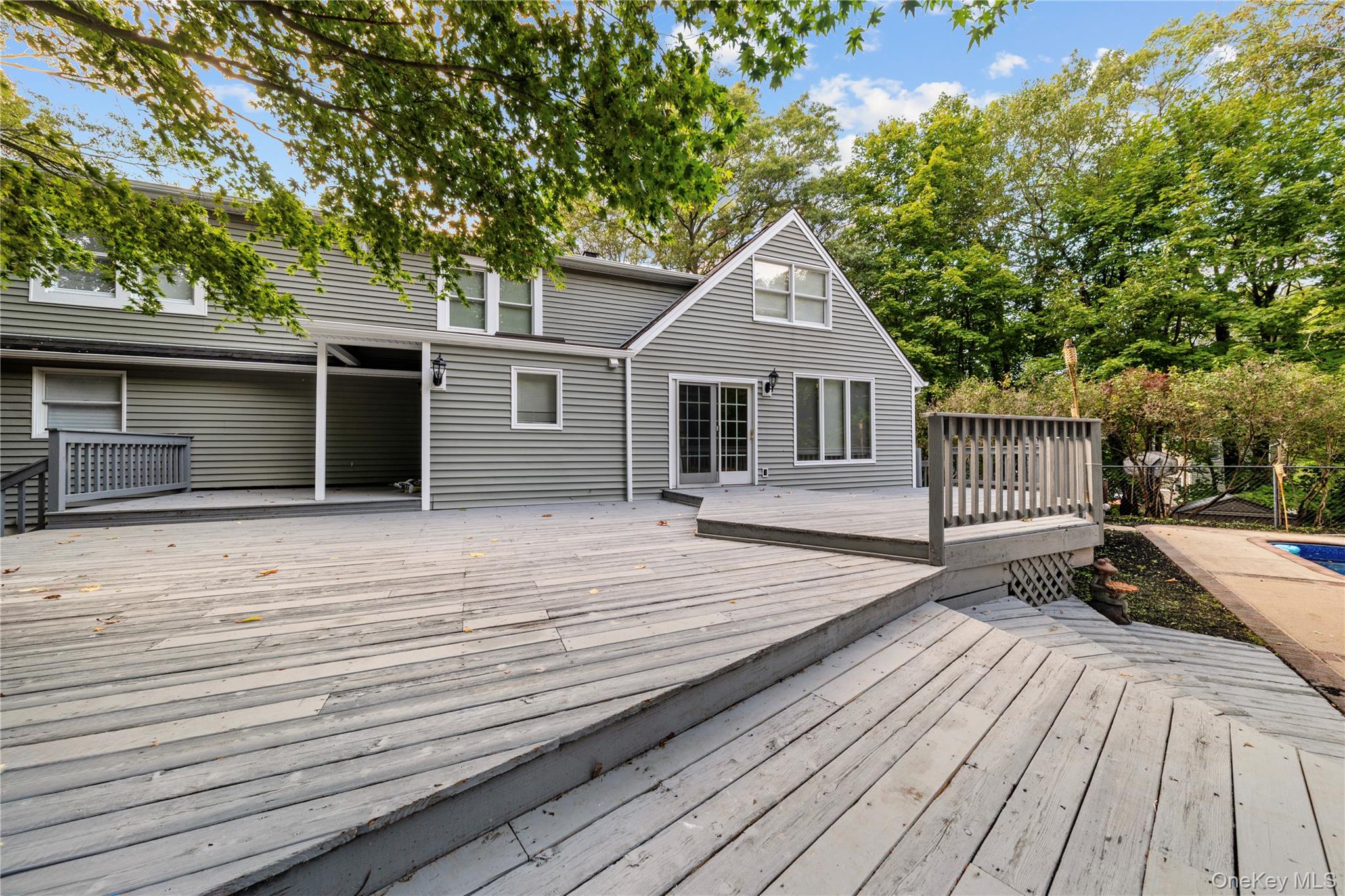 57 Eastwood Road Miller Place, NY 11764 - Photo 36 of 45 a front view of a house with a yard