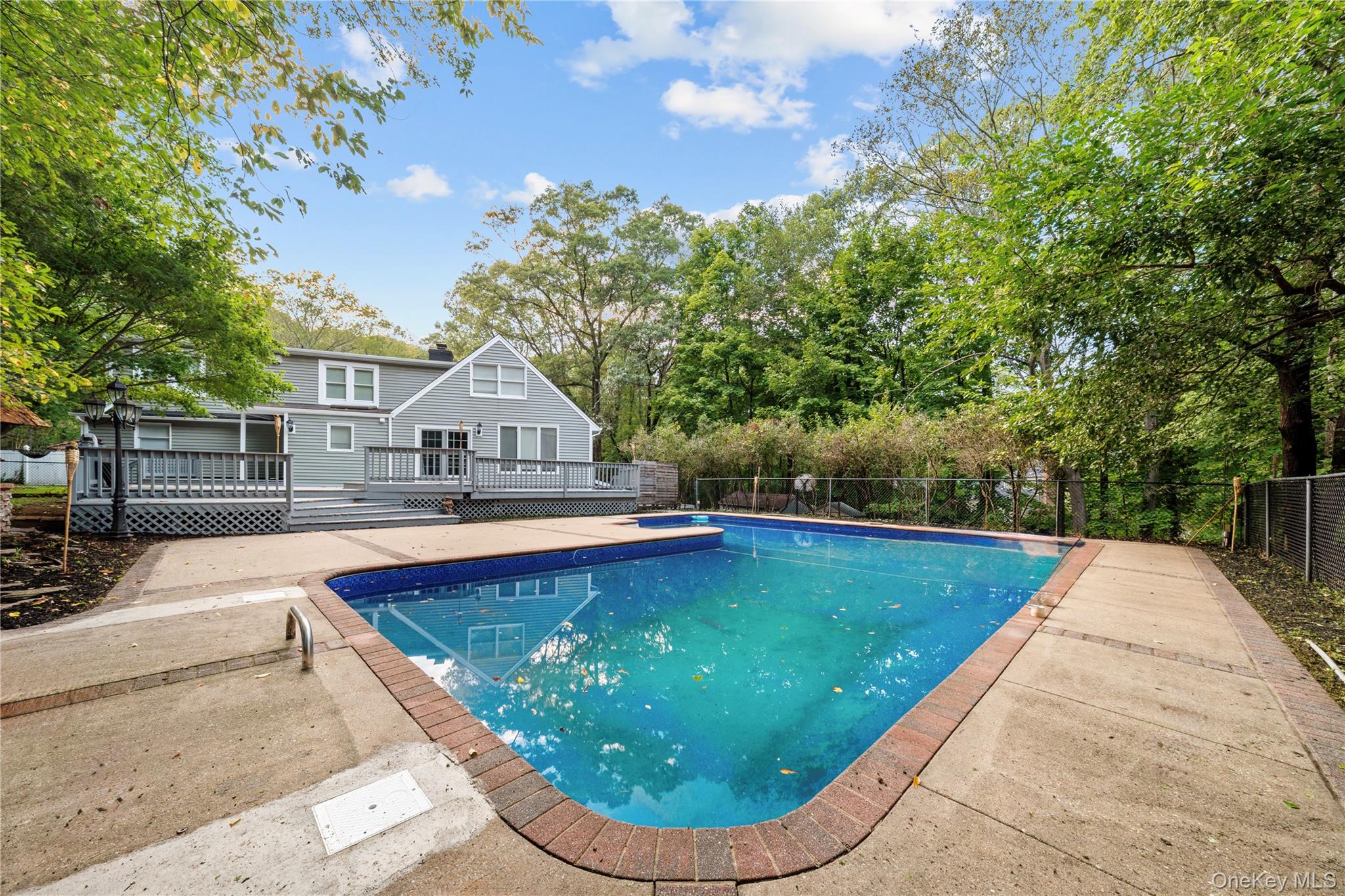 57 Eastwood Road Miller Place, NY 11764 - Photo 38 of 45 a view of a swimming pool with a patio