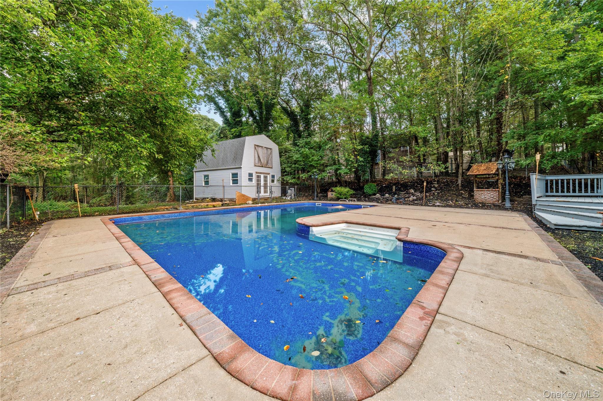 57 Eastwood Road Miller Place, NY 11764 - Photo 40 of 45 a view of a swimming pool with a patio