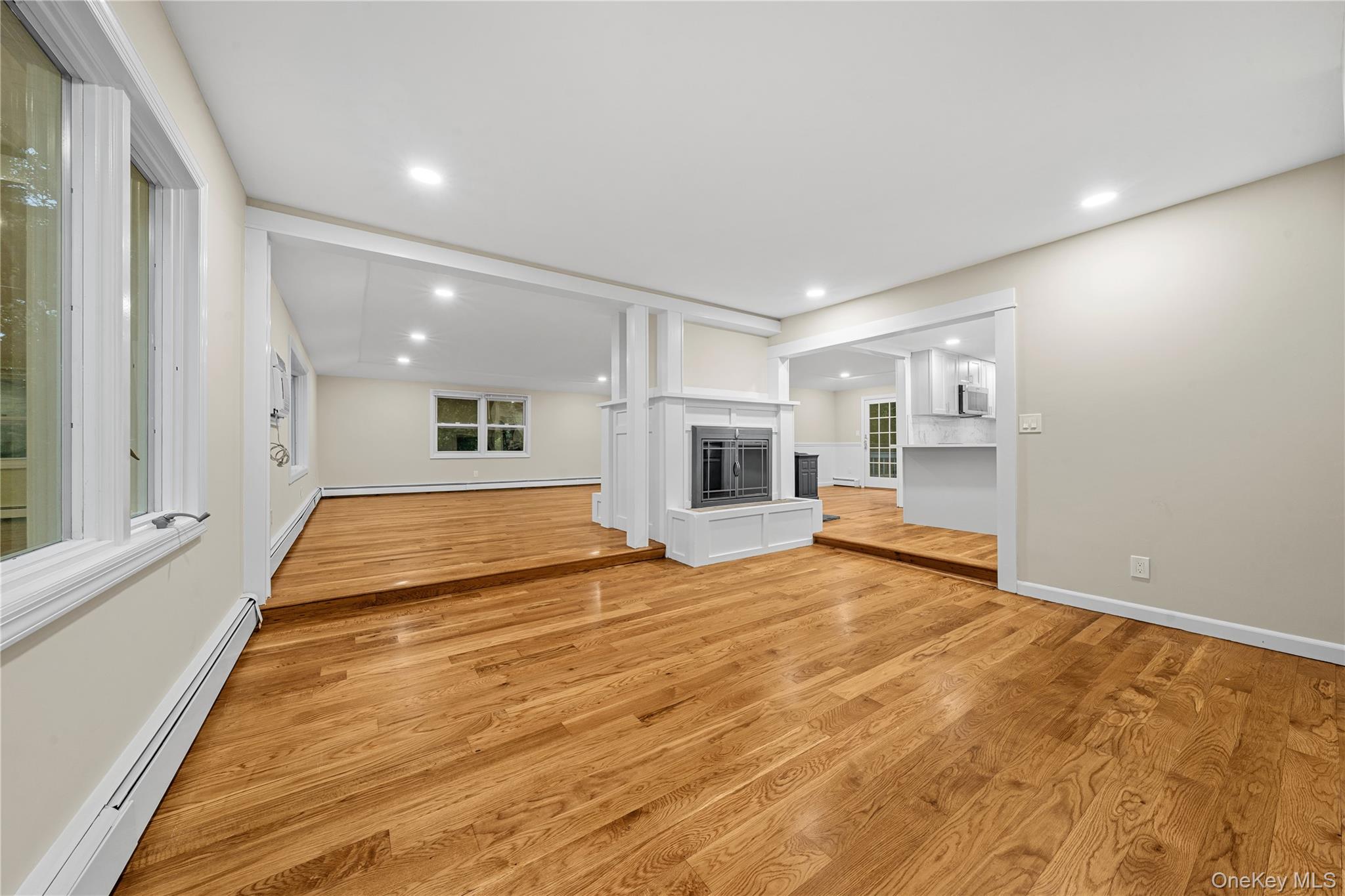57 Eastwood Road Miller Place, NY 11764 - Photo 5 of 45 a view of an empty room with kitchen and a window
