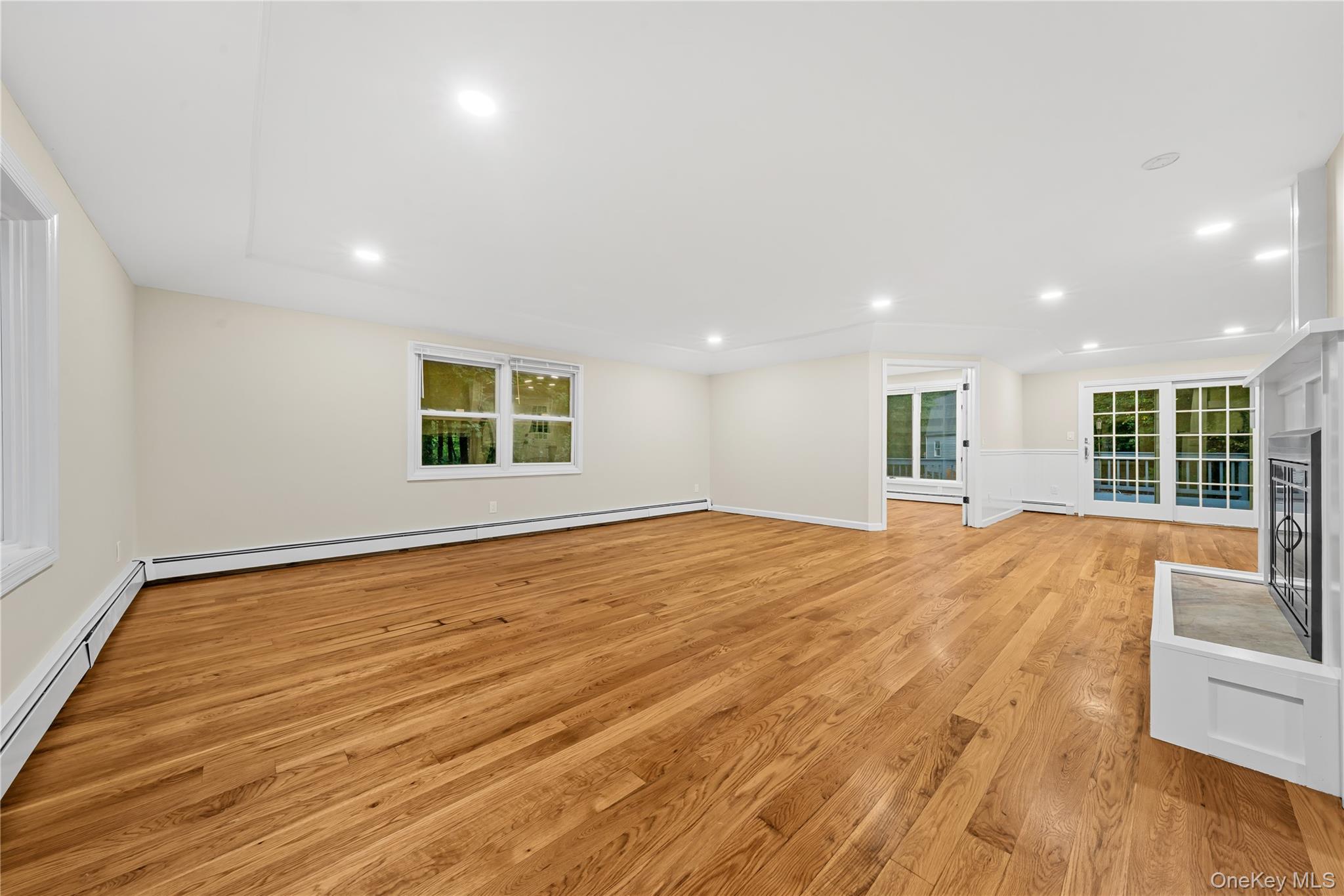 57 Eastwood Road Miller Place, NY 11764 - Photo 6 of 45 a view of empty room with wooden floor and fan