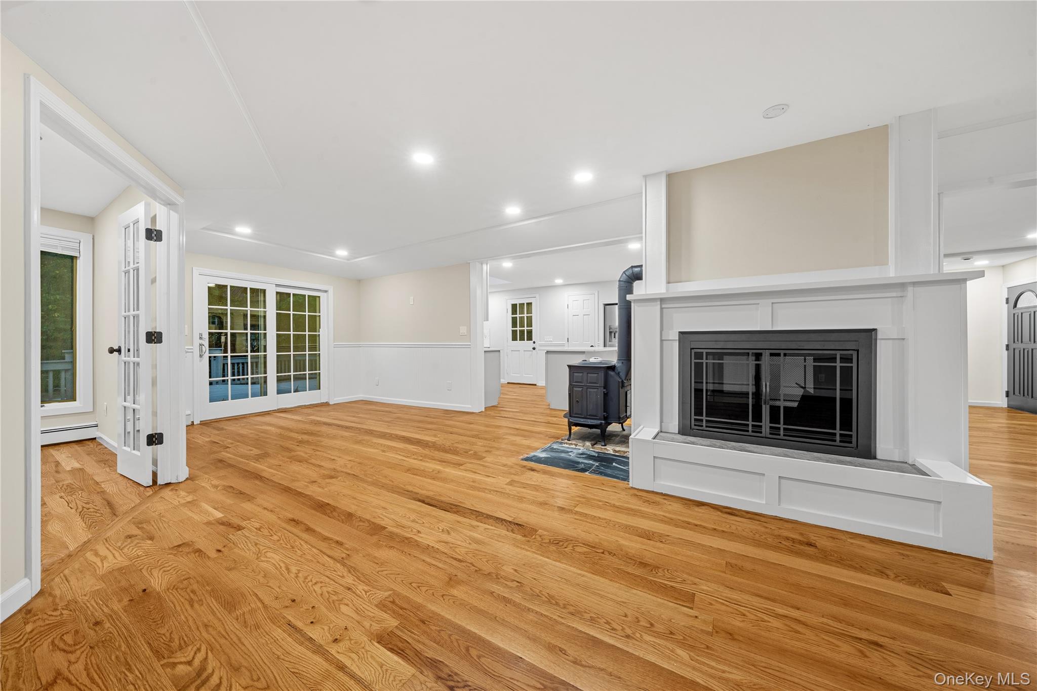 57 Eastwood Road Miller Place, NY 11764 - Photo 8 of 45 a view of empty room with wooden floor and fireplace